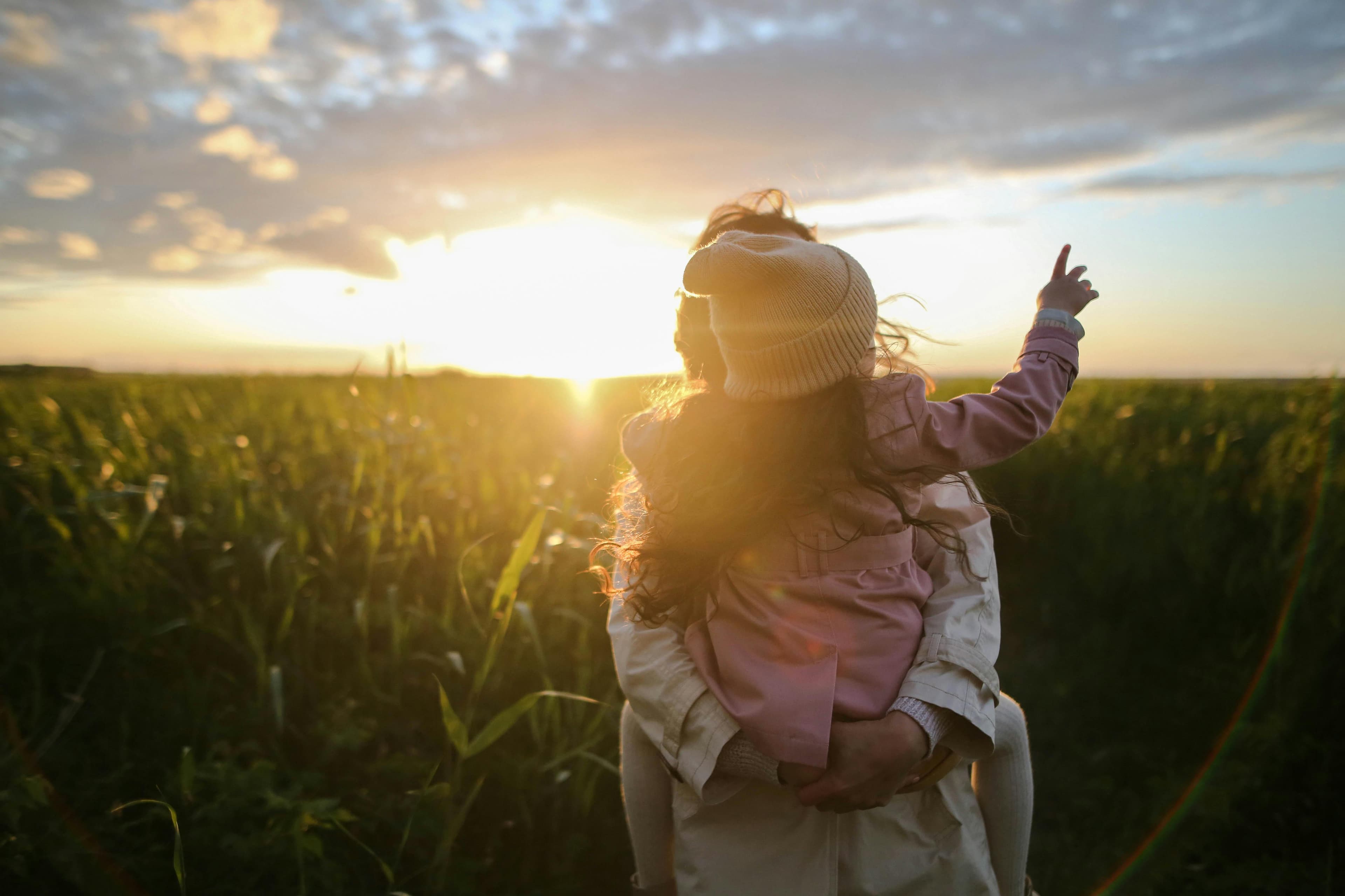 A mother and daughter sharing a quiet sunset; a moment worth remembering.